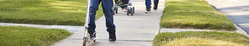 a family using a sidewalk together